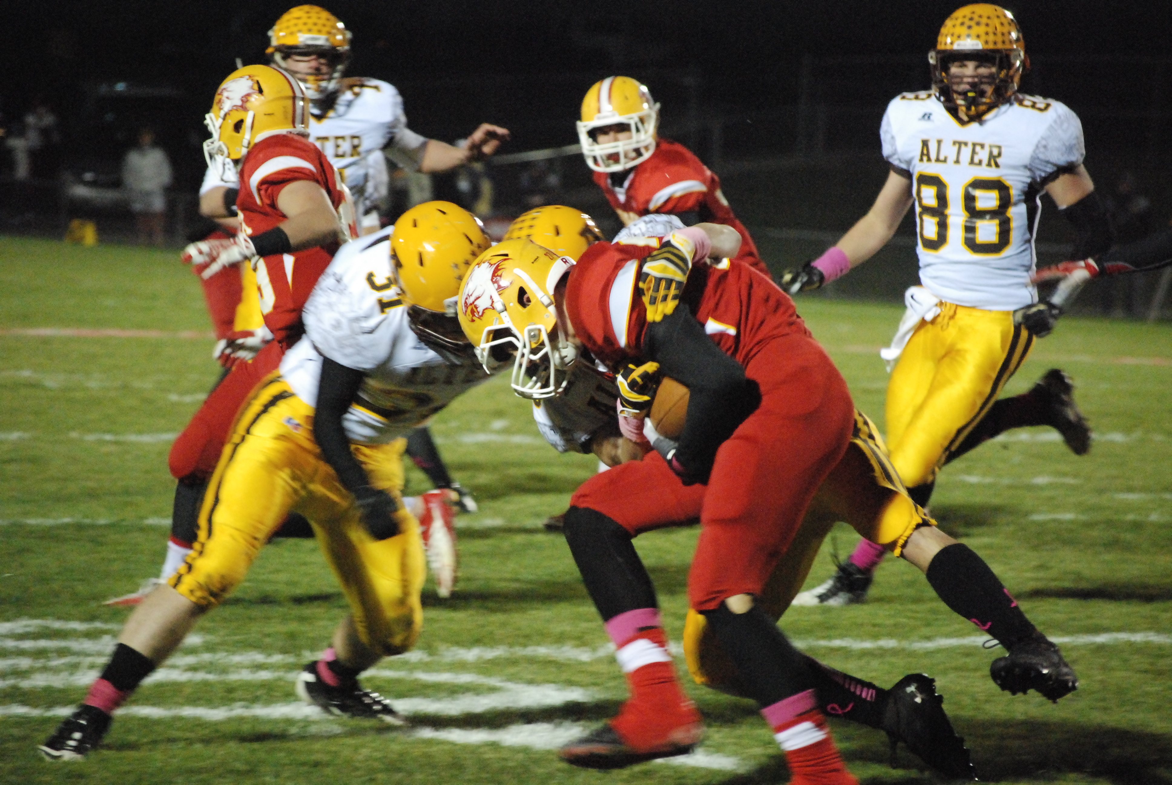 The Alter defense stopped Fenwick running back Frank Catrine on a run late in the first half Thursday night at Krusling Field. Alter held Catrine to 79 total yards and won the game 21-0.